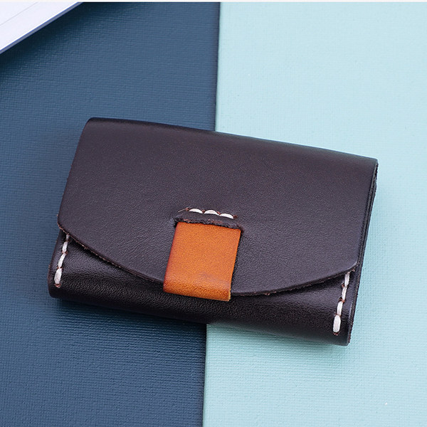 Black Leather Pouch with Orange Accents on a Blue and White Background